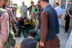 FILE - Relatives gather next to the coffin of a soldier after an ambush blamed on the Taliban killed at least 25 Afghan security force personnel as spiraling violence imperils ongoing peace talks, in Takhar province, Oct. 21, 2020. (AFP)