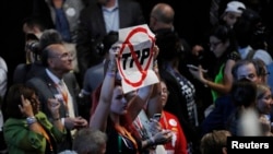 A delegate holds an anti-Trans-Pacific Partnership (TPP) trade agreement sign during the first day of the Democratic National Convention in Philadelphia, July 25, 2016. 