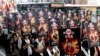 FILE - Activists displaying portraits of people who killed themselves via self-immolation take part in a rally to support Tibet in Taipei, March 10, 2013. 
