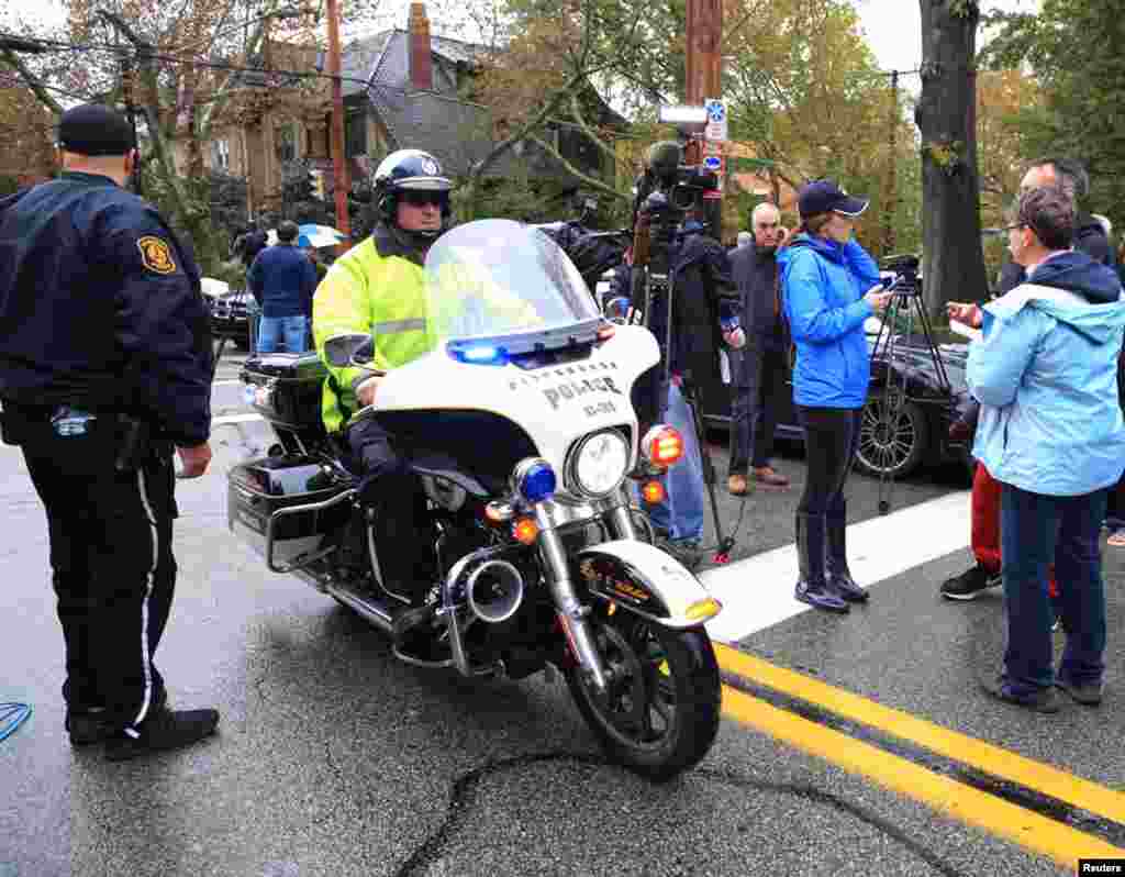 A police officer on a motorcycle passes through a roadblock as he responds after a gunman opened fire at the Tree of Life synagogue in Pittsburgh, Pennsylvania, Oct. 27, 2018.