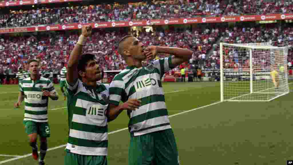 Islam Slimani du Sporting de l'Algérie, à droite, jubile avec ses coéquipiers André Martins, au centre, et Adrien Silva, de la France, après avoir marqué le premier but contre Benfica lors du match de la Ligue de football portugais entre Benfica et le Sporting à Luz le stade de Benfica à Lisbonne, dimanche 31 août 2014.