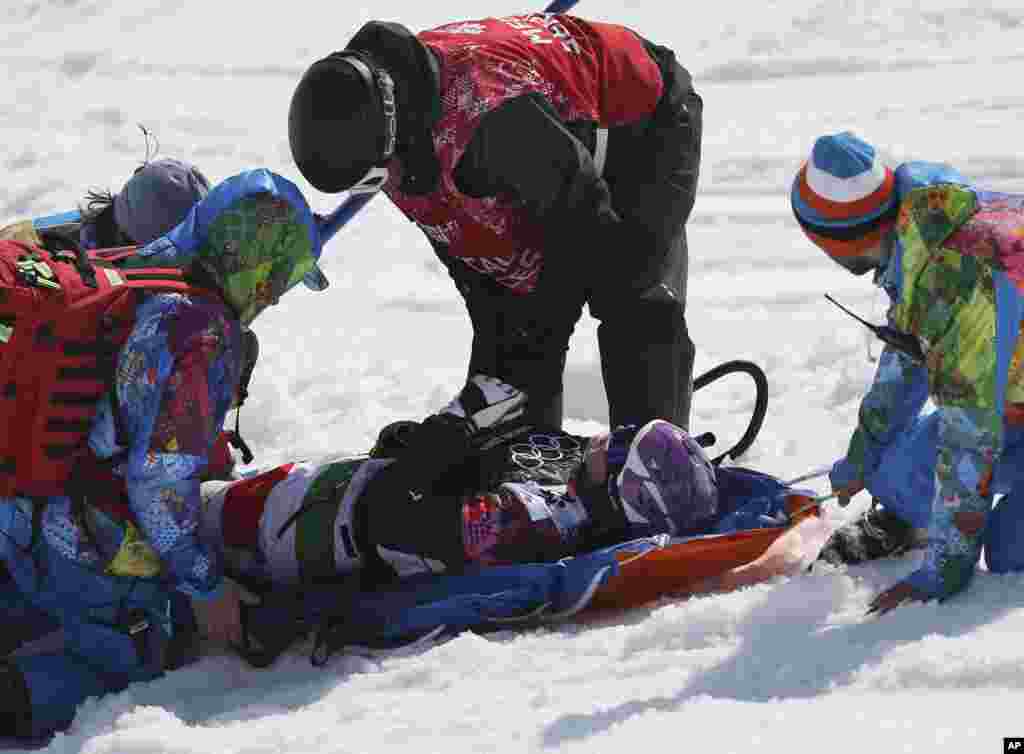 Italy's Michela Moioli is placed on a stretcher after a crash in the women's snowboard final at the Rosa Khutor Extreme Park, in Krasnaya Polyana, Russia, Feb. 16, 2014.