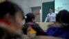 In this Dec. 1, 2009 photo, economist Ilham Tohti speaks to students at the Central Nationalities University in Beijing, China.