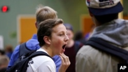 FILE - In this photo taken Nov. 23, 2015, sophomore Ben Early yawns as he stands in his school cafeteria before classes at Roosevelt High School in Seattle. In 2016, the American Medical Association issued a new policy proposal that "encourages middle schools and high schools to start no earlier than 8:30 a.m." (AP Photo/Elaine Thompson)