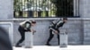 Members of Iranian forces take cover during an attack on the Iranian parliament in central Tehran, Iran, June 7, 2017. 