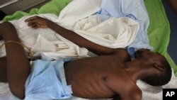 FILE - A man that did not want to be identified lies in a ward that specializes in AIDS treatment at a hospital in Dakar, Senegal.