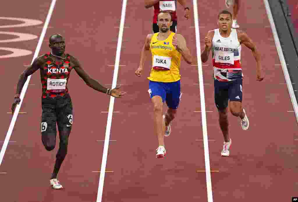 Ferguson Rotich, of Kenya, left, races to the line to win a semifinal of the men's 800-meter ahead of Amel Tuka, of Bosnia and Herzegovina, center, and Elliot Giles, of Britain at the 2020 Summer Olympics, Sunday, Aug. 1, 2021, in Tokyo, Japan. (AP Photo/Charlie Riedel)