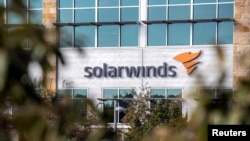 FILE - The SolarWinds logo is seen outside its headquarters in Austin, Texas, Dec. 18, 2020.