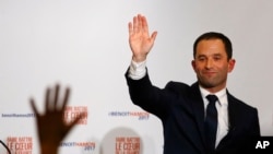 Benoit Hamon greets supporters after winning the socialist party presidential nomination in Paris, France, Sunday, Jan. 29, 2017.