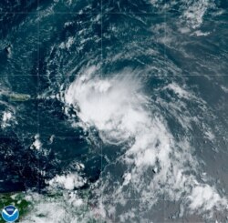 This satellite image released by the National Oceanic and Atmospheric Administration shows Tropical Storm Laura in the North Atlantic Ocean, Aug. 21, 2020.