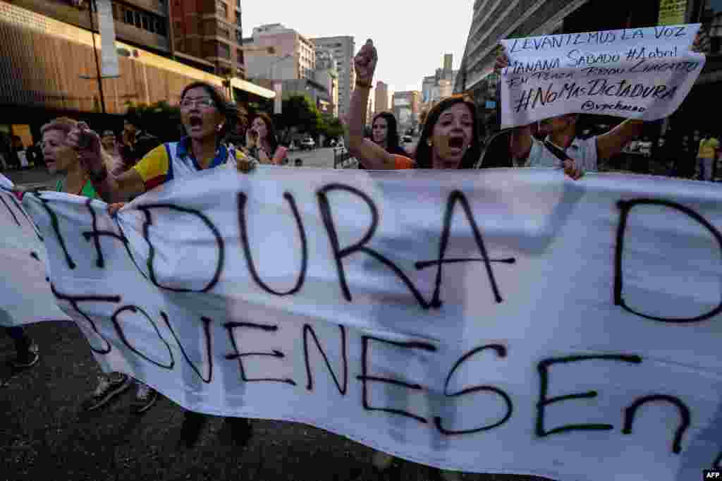 Venezuelan opposition activists, chanting slogans against the government of President Nicolas Maduro, march along a street of Caracas, March 31, 2017.