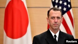 FILE - Admiral John Richardson, chief of U.S. Naval Operations, waits for Japan's Prime Minister Shinzo Abe before their meeting at the prime minister's official residence in Tokyo, Dec. 18, 2017. 