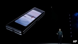 Justin Denison, SVP of Mobile Product Development, talks about the new Samsung Galaxy Fold smartphone during an event Wednesday, Feb. 20, 2019, in San Francisco. (AP Photo/Eric Risberg)