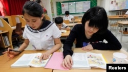 FILE - Students who defected from North Korea take supplementary lessons at the Hangyeore Middle and High School in Anseong, South Korea.
