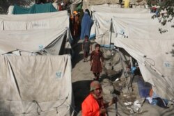 Internally displaced Afghans from northern provinces, who fled their home due to fighting between the Taliban and Afghan security personnel, take refuge in a public park Kabul, Aug. 13, 2021.