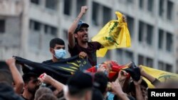 Supporters of Lebanon's Hezbollah leader Sayyed Hassan Nasrallah carry the party's flag in Beirut, Lebanon, Oct. 25, 2019.