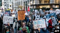 People attend a "Count Every Vote" rally the day after the U.S. election in the Manhattan borough of New York City, New York, U.S., November 4, 2020. REUTERS/Jeenah Moon