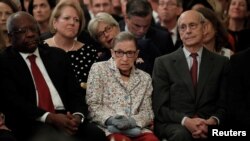 U.S. Supreme Court Associate Justices, from left, Clarence Thomas, Ruth Bader Ginsburg and Stephen Breyer watch from the front row as Brett Kavanaugh takes his ceremonial oath of office while participating in a ceremonial public swearing-in in the East Ro