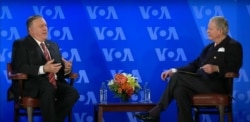 FILE - Secretary of State Michael Pompeo has a conversation with VOA Director Robert Reilly at the Voice of America headquarters in Washington, Jan. 11, 2021.