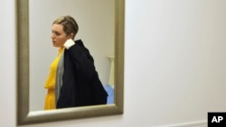 Heidi Wyandt, 27, puts on her coat to leave the Altoona Center for Clinical Research in Altoona, Pennsylvania., March 29, 2017, where she is helping test an experimental non-opioid pain medication for chronic back pain related to a work related injury she received in 2014.