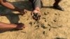FILE - Residents hold bullet shells in a village in Rathedaung township, Rakhine state, Jan. 28, 2019, where fighting between the Myanmar military and ethnic Arakan Army (AA) took place from January 26 to 28.
