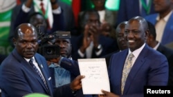 Mwenyekiti wa IEBC Wafuta Chebukati akimkabidhi William Ruto hati ya ushindi wa urais baada ya kutangaza matokeo.