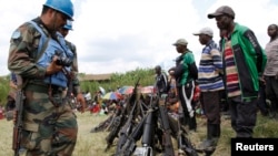 Des casques bleus ont récupéré quelques armes sur des comabattants Forces démocratiques pour la libération du Rwanda (FDLR) après leur reddition en Kateku, une petite ville dans la région orientale de la République démocratique du Congo (RDC), 30 mai 2014.
United Nations peace keepers record details of weapons recovered from the Democratic Forces for the Liberation of Rwanda (FDLR) militants after their surrender in Kateku, a small town in eastern region of the Democratic Republic of Congo (DRC), May 30, 20