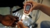 FILE - A paramedic checks the blood sugar level of a patient at a diabetes clinic in Jakarta, Indonesia, April 22, 2016.