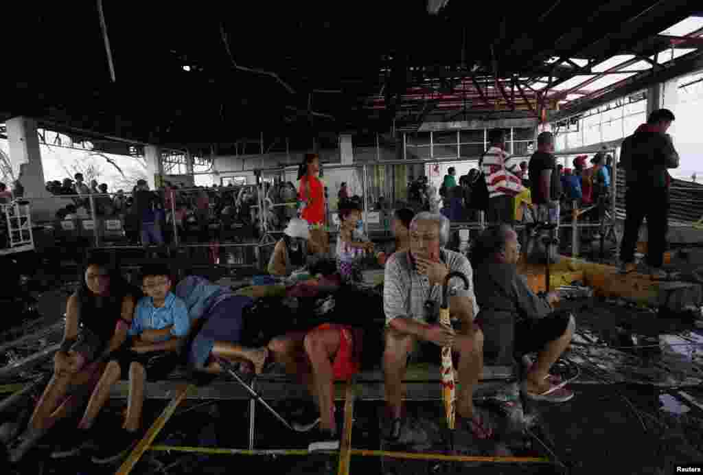Tacloban residents wait for military flights inside the terminal of Tacloban airport, Nov. 12, 2013.
