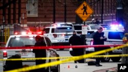 Crime scene investigators collect evidence from the pavement as police respond to an attack on campus at Ohio State University, Nov. 28, 2016, in Columbus, Ohio.