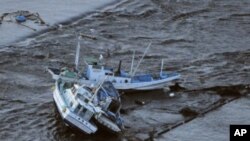 Fishing boats are swept by a tsunami in Oarai City in Ibaragi Prefecture, northeastern Japan March 11, 2011.