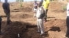 Some of the people involved in the demining exercise showing part of the area that has been cleared of landmines.