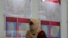 A staff member from Malaysia's Election Commission walks past a map showing state assembly areas at its office in Putrajaya, Malaysia, Oct. 20, 2022.
