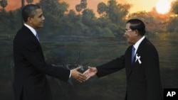 U.S. President Barack Obama, left, is greeted by Cambodia's Prime Minister Hun Sen before the ASEAN-U.S. leaders meeting in Phnom Penh, Cambodia, Monday, Nov. 19, 2012. (AP Photo/Vincent Thian)