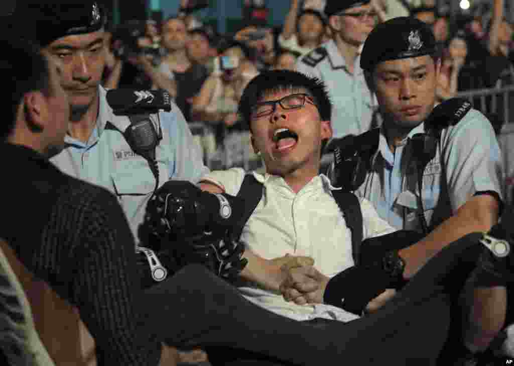 香港民主运动人士黄之锋6月28日晚在金紫荆广场示威的时候爬上金紫荆巨型雕塑,后来被警察拘留。当时当地被拘押的还有香港民主运动人士罗冠聪等20多名抗议者。