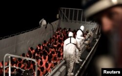 Migrants are rescued by staff members of the MV Aquarius, a search and rescue ship run in partnership between SOS Mediterranee and Medecins Sans Frontieres in the central Mediterranean Sea, June 10, 2018. (Karpov/handout via Reuters)