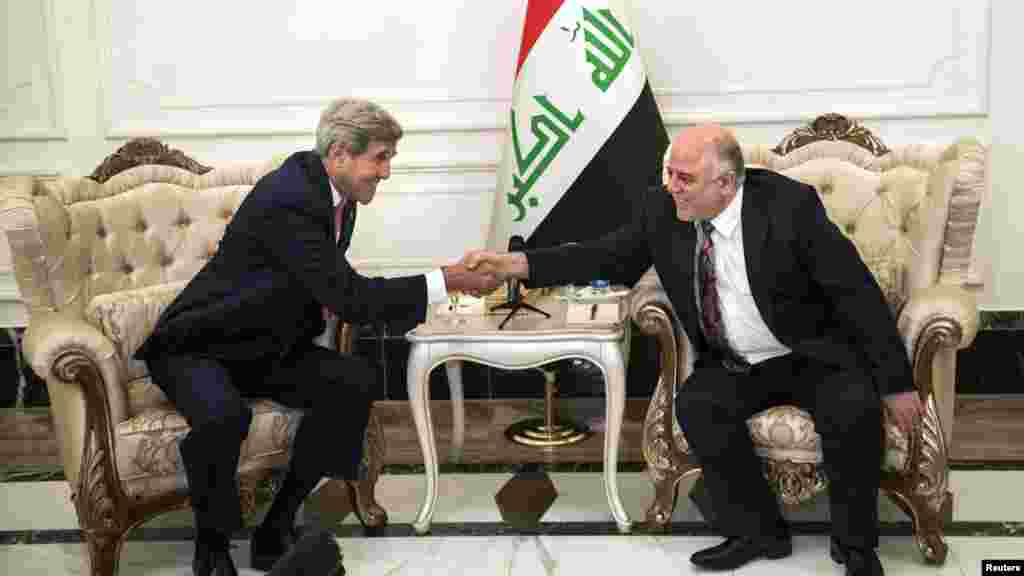 U.S. Secretary of State John Kerry, left, and new Iraqi Prime Minister Haider al-Abadi shake hands after a meeting in Baghdad Sept. 10, 2014.