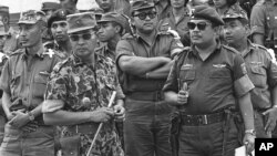 Maj. Gen. Suharto, 2nd left with sunglasses, is shown in this Oct. 6, 1965 file photo. The late dictator was an army general who crushed Indonesia's communist movement and pushed aside the country's founding father to usher in 32 years of tough rule.