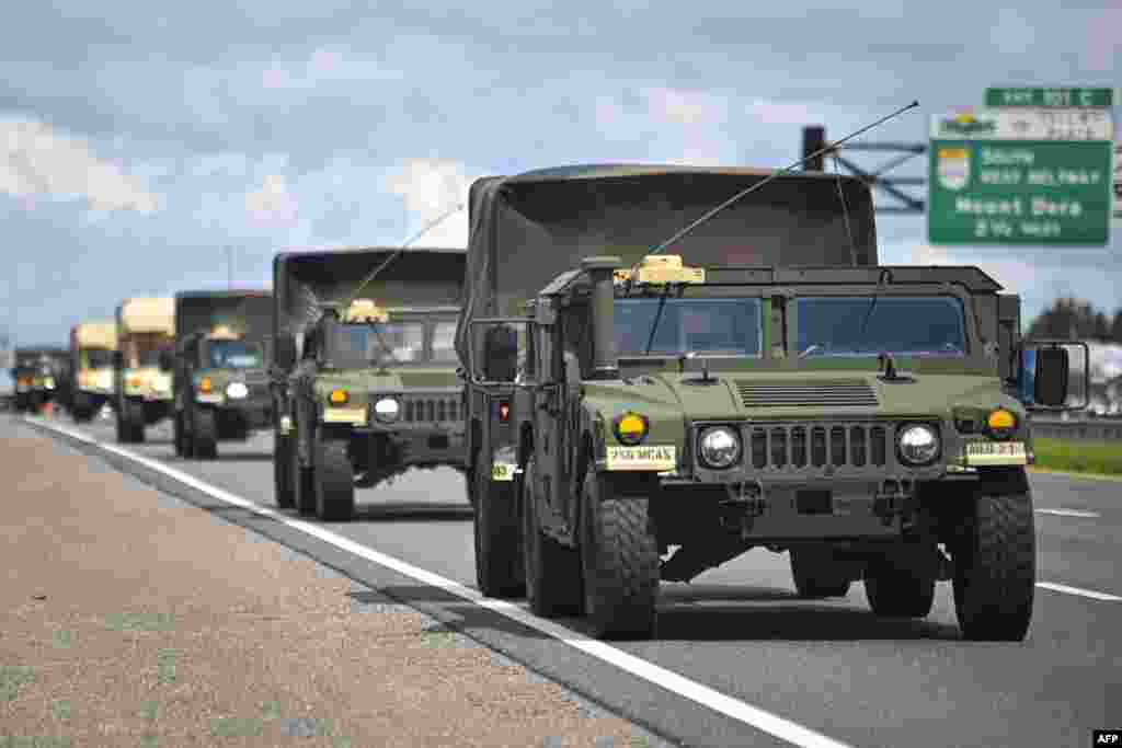 A military convoy is seen ahead of Hurricane Milton's expected mid-week landfall in Sanford, Florida, Oct. 8, 2024. 