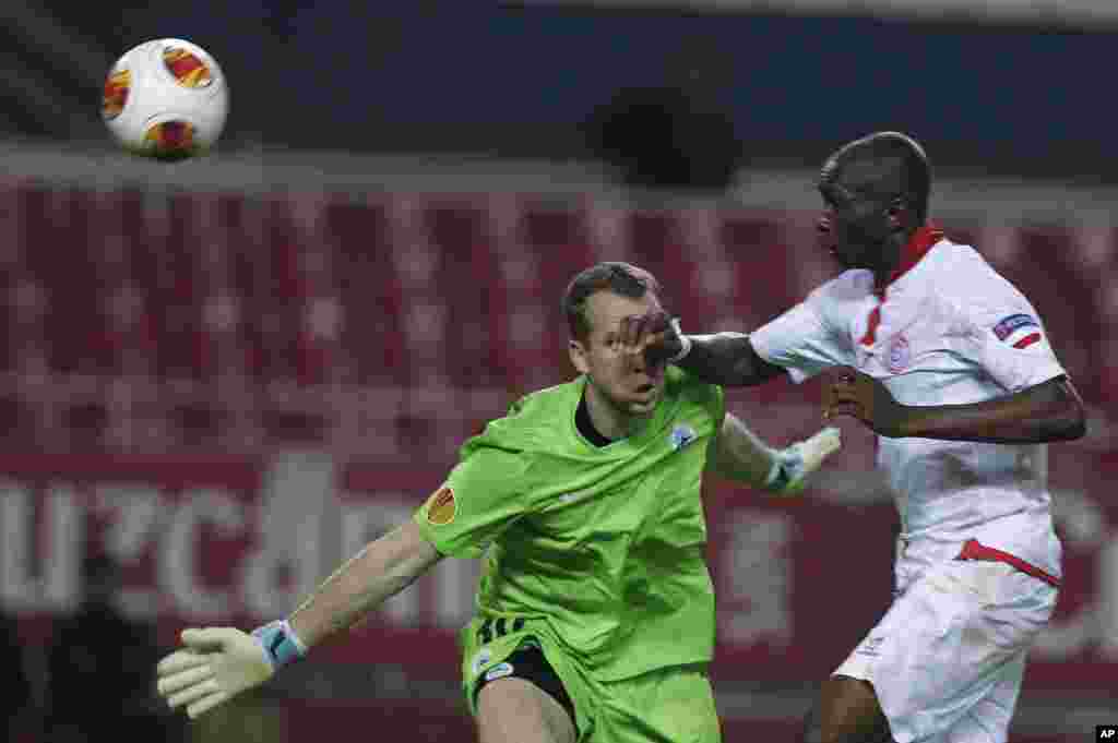 Stéphane Mbia de Séville, à droite, saute pour prendre la balle avant Lukas Hrosso de Liberec, à gauche, lors de leur match du groupe H de la Ligue Européenne au stade Ramon Sanchez Pizjuan à Séville, en Espagne, jeudi 7 novembre 2013.