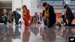 House Speaker Nancy Pelosi, center, and other members of Congress, kneel and observe a moment of silence at the Capitol on June 8, 2020, on Capitol Hill in Washington, reading the names of George Floyd and others killed during police interactions. (AP Photo/Manuel Balce Ceneta)