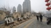 People walk past an Evergrande Group residential complex called Evergrande Palace in Beijing on Jan. 30, 2024.