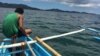 FILE - Vietnam, China and the Philippines all claim at least a portion of the Spratly archipelago. Here, a fisherman sails into waters of the South China Sea, Sept. 15, 2014.