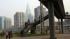 FILE - North Koreans walk on a pedestrian bridge in Pyongyang.