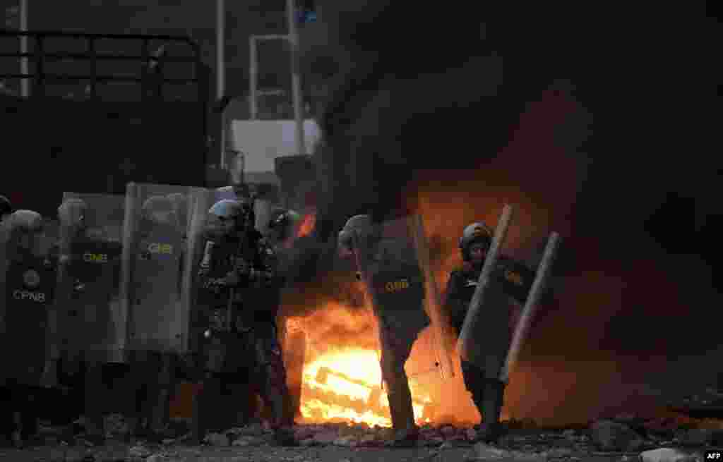Venezuelan security forces clash with supporters of Venezuelan opposition leader Juan Guaido on the Venezuelan side of the Francisco de Paula Santander International Bridge, as seen from Cucuta, Colombia, Feb. 25, 2019.