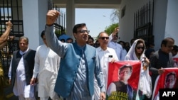 Parliamentarians of the Pakistan Tehreek-e-Insaf party carry posters of jailed former Prime Minister Imran Khan, during a protest outside the Parliament house in Islamabad on July 18, 2024. The party on July 20 said several members were "abducted."
