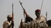 FILE - Sudanese soldiers from the Rapid Support Forces unit, led by Gen. Mohammed Hamdan Dagalo, the deputy head of the military council, secure the area in the East Nile province, Sudan, June 22, 2019. 