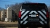 FILE - A police vehicle sits outside of the Congregation Beth Israel Synagogue in Colleyville, Texas, some 25 miles (40 kilometers) west of Dallas, Jan. 16, 2022.