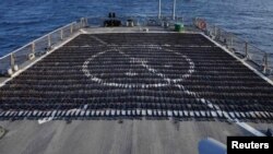 Thousands of AK-47 assault rifles, seized from a fishing vessel transiting along a maritime route from Iran to Yemen, sit on the flight deck of guided-missile destroyer USS The Sullivans (DDG 68) during an inventory process, in the Gulf of Oman in Arabian Sea, in this photo taken on Jan. 7, 2023 and released by U.S. Naval Forces on Jan. 10, 2023.
