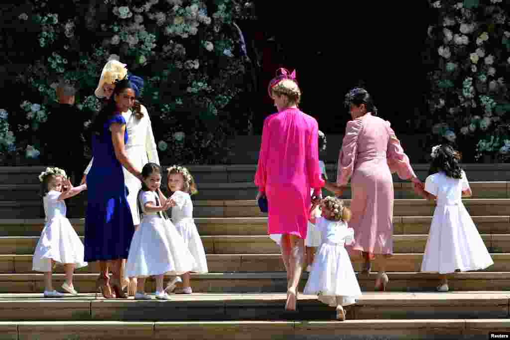 Britain's Catherine, Duchess of Cambridge and Meghan Markle's friend, Canadian fashion stylist Jessica Mulroney holds bridesmaids hands as they arrive for the wedding ceremony of Britain's Prince Harry, Duke of Sussex and U.S. actress Meghan Markle at St George's Chapel, Windsor Castle in Windsor, Britain, May 19, 2018.